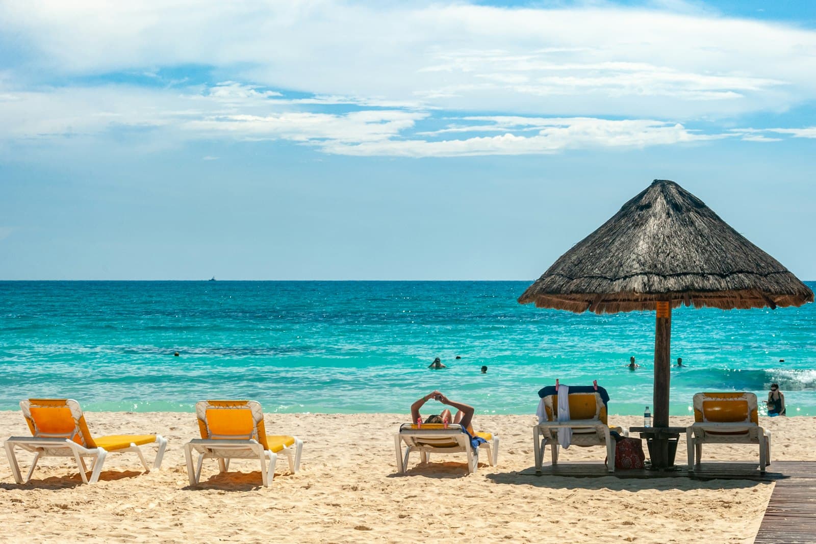 Turquoise sea and a palapa umbrella on a beach in Cancún