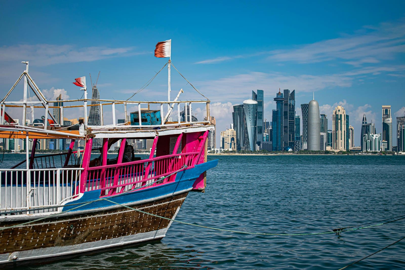 A traditional dhow boat in front of the Doha skyline