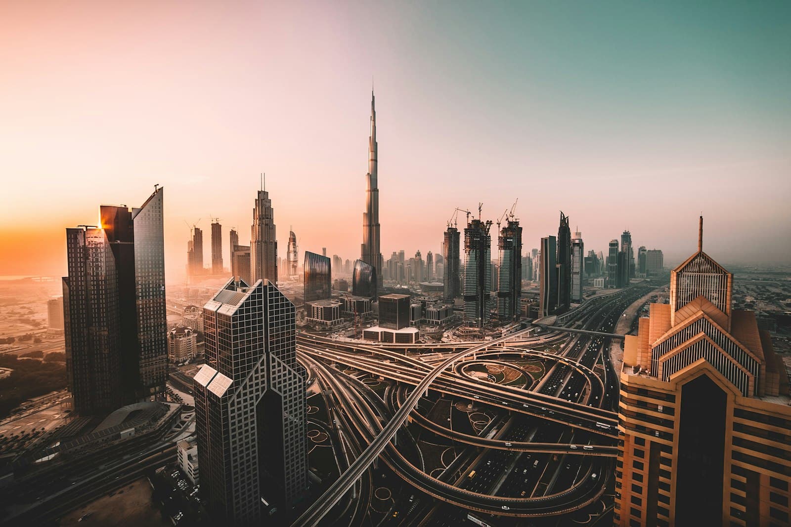 The Burj Khalifa and Dubai skyline above multi-level highways