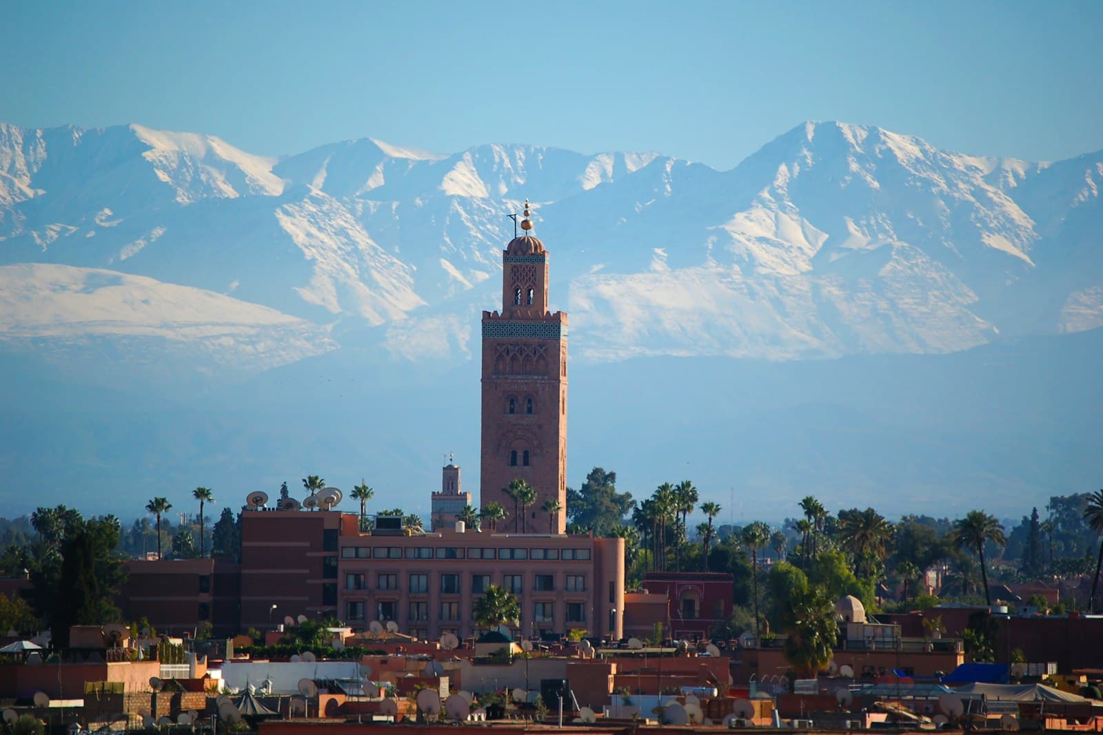 Koutoubia Mosque with the snowy Atlas Mountains behind Marrakech
