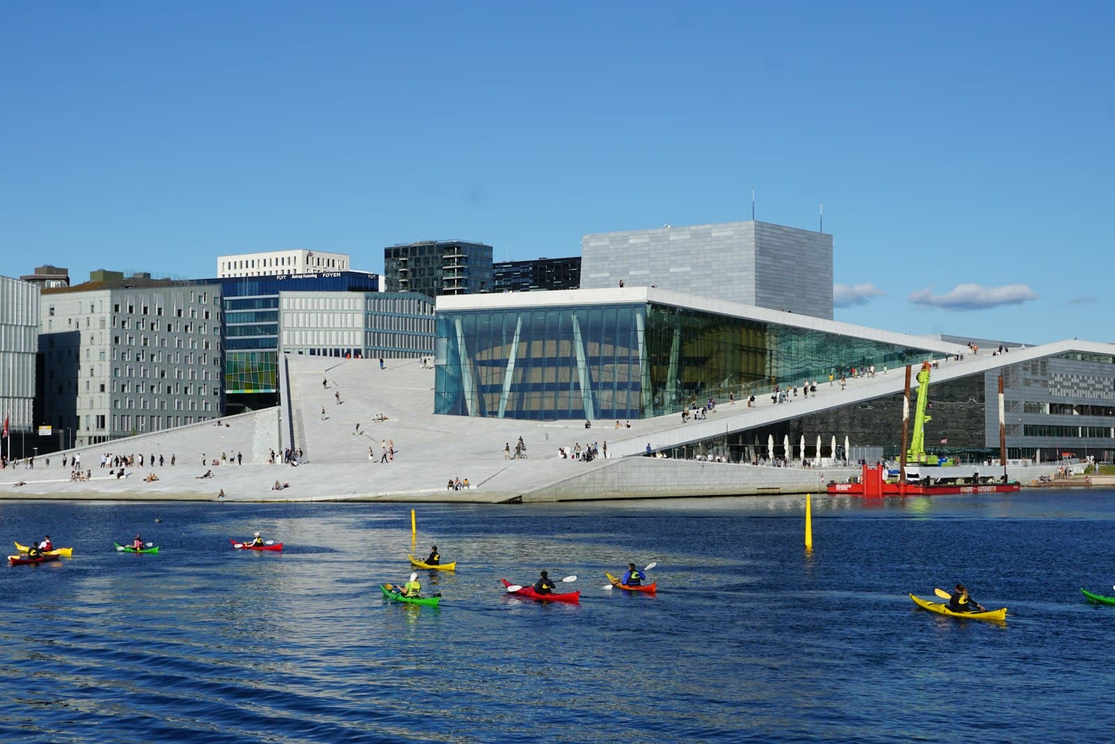Oslo Opera House by the fjord with kayaks on the water