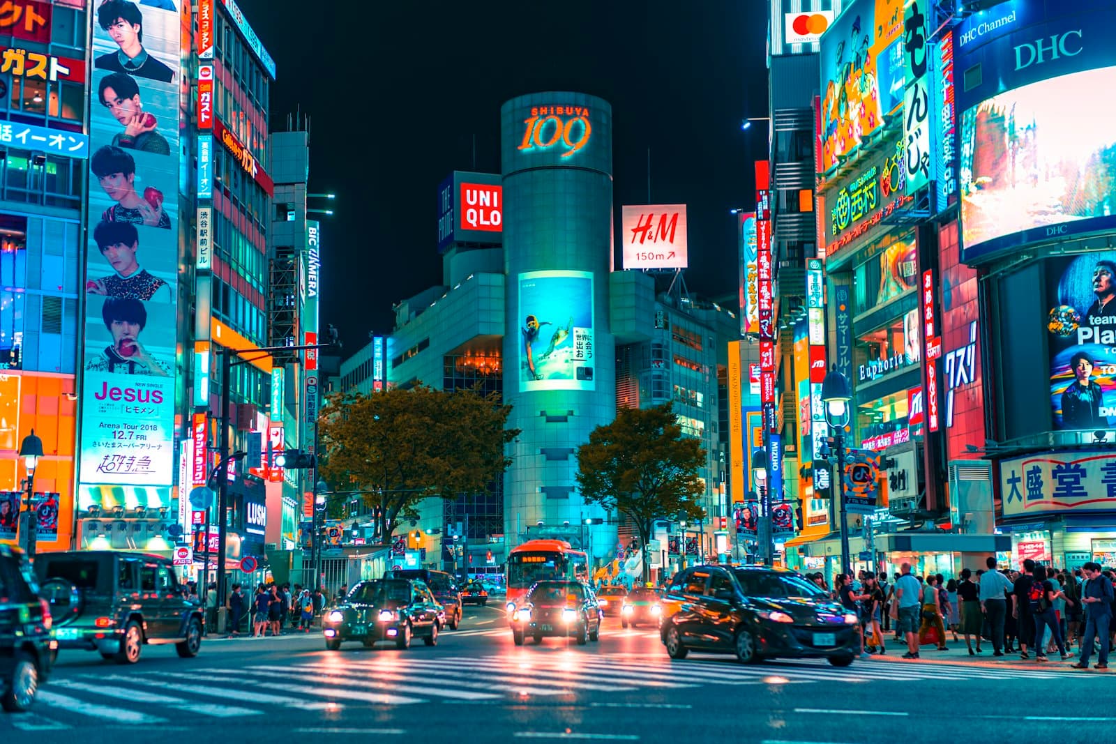 Neon signs and traffic at Shibuya crossing in Tokyo at night